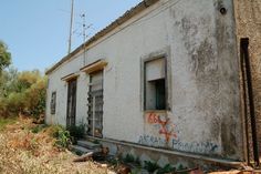 an old run down building with graffiti on it