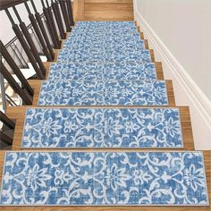 three blue rugs are on the stairs