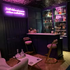 a bar with purple lighting and chairs