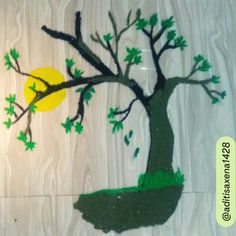 this is an image of a tree painted on the wall with green leaves and yellow moon