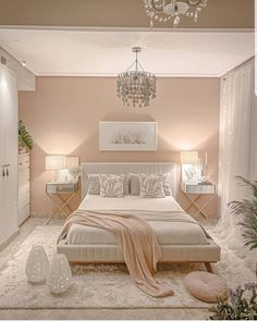 a bedroom with pink walls and white furniture