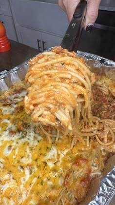 a person is cutting up some food on a pan