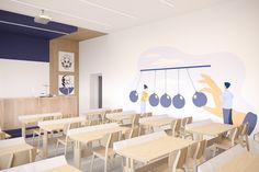 an empty classroom with wooden desks and white walls, decorated with hanging ornaments on the wall