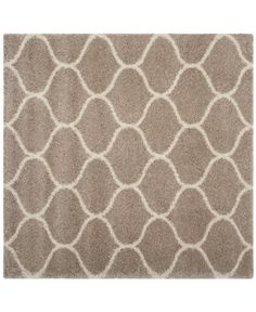 an area rug with white circles and wavy lines on the side, in light brown