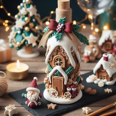 a christmas scene with gingerbread houses, candles and other holiday decorations on a table