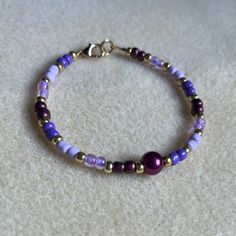 - One Of A Kind Beaded Bracelet - Featuring Light Purple, Dark Purple, And Gold Seed Beads With A White Pearl Bead At The Center - Gold Colored Hardware - Clasps Closed. No Stretch. - Size/ Circumference Is 7” - Handmade (By Myself). Perfect To Treat Yourself Or To Give As A Unique Gift! **Add 2 Jewelry Items Marked “2 For $20” To Your Bundle And I Will Send You An Offer For $20** Tags: Beaded, Handmade Jewelry, Colorblock, Ocean, Pearls Check Out The “Boutique” Tab In My Closet For Handmade Ear Elegant Purple Beaded Bracelets With Tiny Beads, Elegant Purple Bracelets With Colorful Beads, Elegant Purple Bracelet With Colorful Beads, Purple Round Beads For Jewelry Making, Elegant Purple Beaded Bracelet With Colorful Beads, Single Strand Purple Beads For Gift, Purple Single Strand Beads For Gift, Elegant Hypoallergenic Purple Beaded Bracelets, Purple Single Strand Beads As A Gift