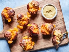 some food is sitting on a wooden cutting board