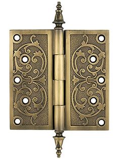 an antique brass door hinge with ornate designs on the front and side panels,