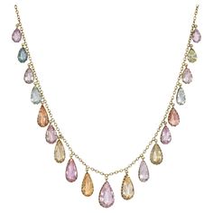 An antique Victorian period gold and topaz necklace of fringe design, comprising graduated precious topaz pear-shaped drop pendants in an array of pastel colors, in 14k. Largest stone measures approximately 16mm long x 10mm at widest point; smallest is about 8mm long x 4mm at widest * Includes letter of authenticity * Free shipping Platinum Necklace, Festoon Necklace, M Jewelry, Victorian Period, Diamonds And Pearls, Topaz Necklace, Bow Necklace, Fringe Necklace, Pearl Diamond