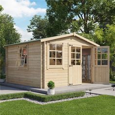 a small wooden shed sitting on top of a lush green field