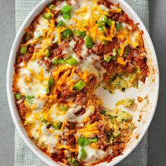 a casserole dish with meat, cheese and green peppers in it on a towel