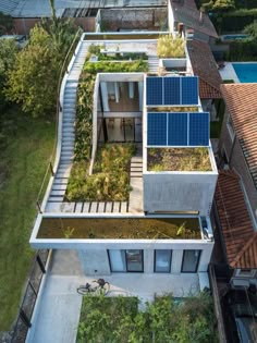 an aerial view of a house with solar panels on the roof