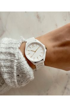 Gleaming goldtone markers and indices add a flash of sophistication to this dazzling white ceramic bracelet watch. Ceramic Imported Watches Women Aesthetic, Aesthetic Watches For Women, Mvmt Watches Women, Wrist Watches For Women, Movado Womens Watch, White Watches Women, Homemade Pillows, Mvmt Watches, Classic Jewelry Pieces