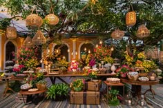 a room filled with lots of different types of flowers and plants on top of tables