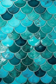 a close up view of the scales of a blue fish scale pattern on a wall