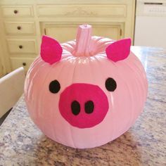 a pink pig pumpkin sitting on top of a counter