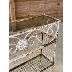 an old metal shelf with a glass top