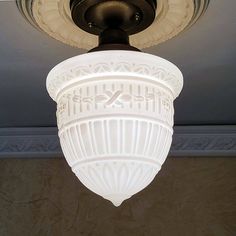 a white light fixture hanging from the ceiling