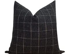 a black and white checkered pillow on a white background