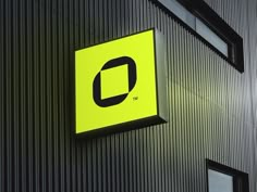 a sign on the side of a building that says,'o'in black and yellow