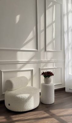 a white chair and ottoman in a room