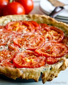 a tomato pie sitting on top of a wooden table