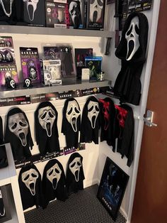 a room filled with lots of masks on the wall next to a shelf full of books