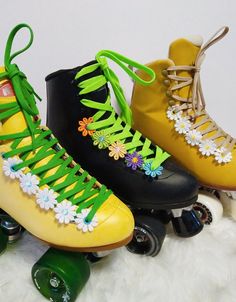 three roller skates decorated with flowers and laces on top of white furnishing