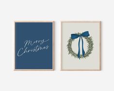 two framed christmas cards with blue ribbon and green wreath on the front, one has a merry