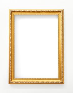 an empty gold frame hanging on the wall