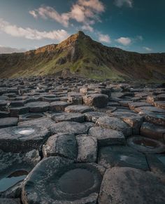 the giant stones are all stacked together on top of each other, with a mountain in the background