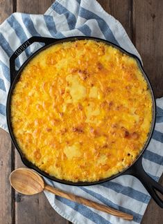 baked cheesy mac and cheese in a cast iron skillet with text overlay