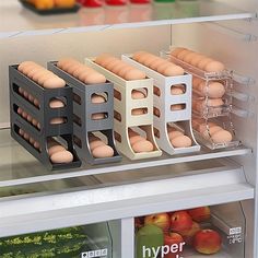 an open refrigerator filled with eggs and oranges on the shelf next to other food items