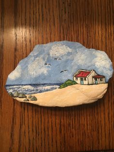 a rock with a house painted on it