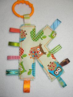 an owl and giraffe design baby pacifier clip set on a white background