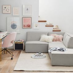 a living room filled with furniture and lots of pictures on the wall above it's desk