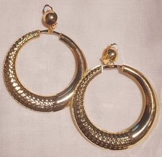 These are unique and rare  Large Clip on Bamboo Hoop Earrings chunky style Gold metal They hang 3 inches  These are very lightweight on the ear Easy to wear These Earrings are a classic and urban addition to any Wardrobe Earrings Gold