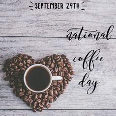 a cup of coffee sitting on top of a pile of coffee beans in the shape of a heart