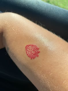 a person with a red tattoo on their arm