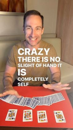 a man sitting at a table with cards in front of him that says crazy there is no sight of hand it is completely selfie