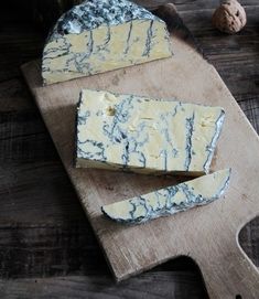 some cheese is sitting on a cutting board