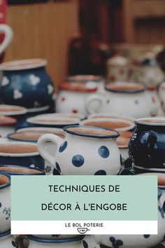 a table topped with lots of cups and saucers covered in polka dotty paint