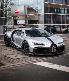 a bugatti car parked in front of a building