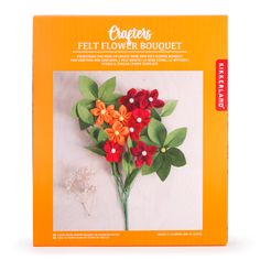 an orange box with red flowers and green leaves on it's side, in front of a white background