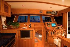 the interior of a boat with wood paneling and blue counter tops, along with other items