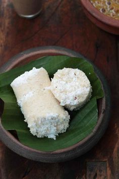 two pieces of food sitting on top of a green leaf