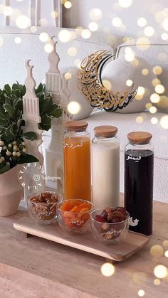 a wooden tray topped with different types of food next to a vase filled with flowers