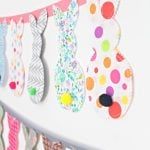 colorful paper buntings are hanging on the wall with polka dots and bunny ears