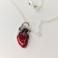 I had a request for some anatomical Heart Jewellery, and when these charms arrived, I knew they had to be necklaces! They are so edgy and cool. All orders are packaged with care. Each box includes tissue paper, a tealight and a KelZo postcard. Product details: Metal and acrylic charm on an approx 18" stainless steel chain with lobster clasp ****Colours may vary slightly from image due to resolution differences. Colour patterns may not match photographed item but will be cut from same piece/colle Valentine's Day Heart-shaped Themed Jewelry, Valentine's Day Heart Shaped Themed Jewelry, Valentine's Day Themed Heart Jewelry, Themed Heart-shaped Jewelry Gift, Red Themed Necklace For Gift, Themed Red Necklace For Gifts, Themed Red Necklace For Gift, Anatomical Heart Jewelry, Heart Jewellery