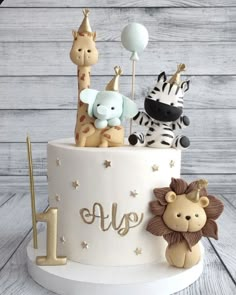 a birthday cake decorated with animals and balloons